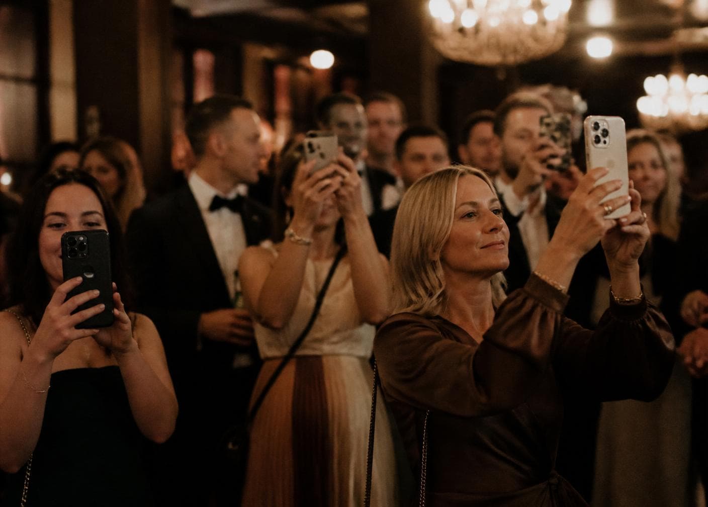 Wedding guests photographing the reception on their phones